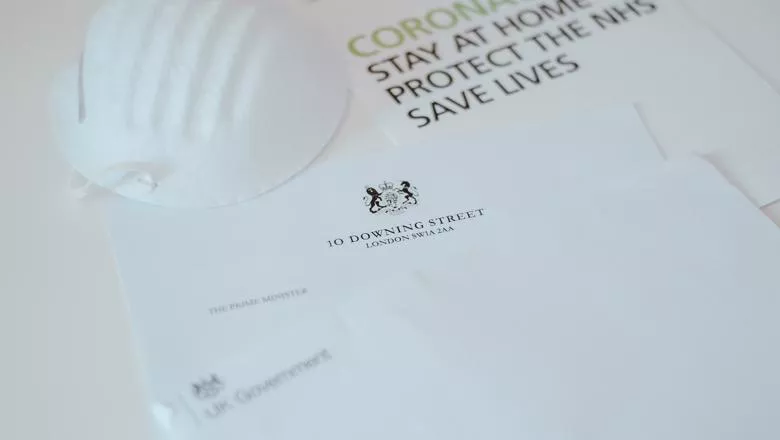 Letter from 10 Downing Street with a face mask on top