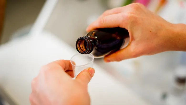 close up of medicine being poured
