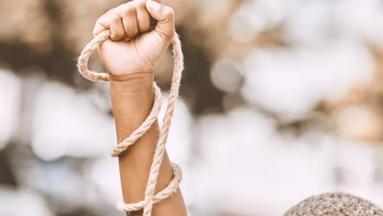 Banner promoting the event which includes a picture of a persons hand with rope around it