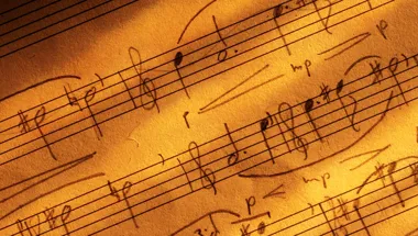 Close up of sheet music in warm yellow light