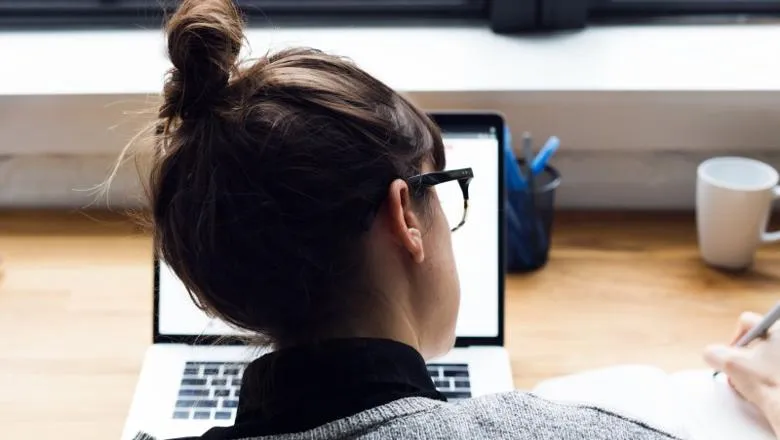 Feature Student on laptop taking notes