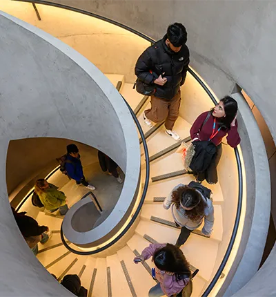People walking down a spiral staircase