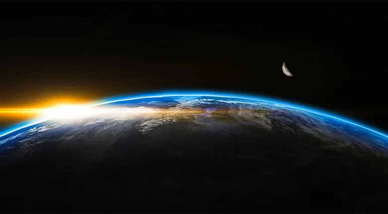 A section of the Earth, with space and the moon in the background.