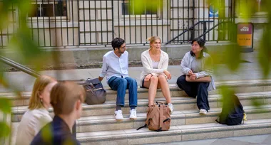 Group of students sitting on stairs, chatting
