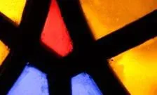 close up image of a stained glass window with a red, yellow and blue design