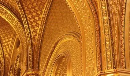 Image of golden walls with intricate designs.