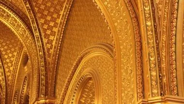 Image of golden walls with intricate designs.