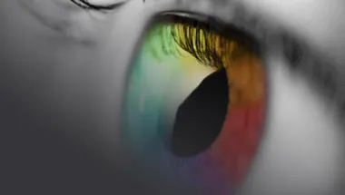 Black & White image of an eye that has been edited to display the iris of the eye in multicolours 