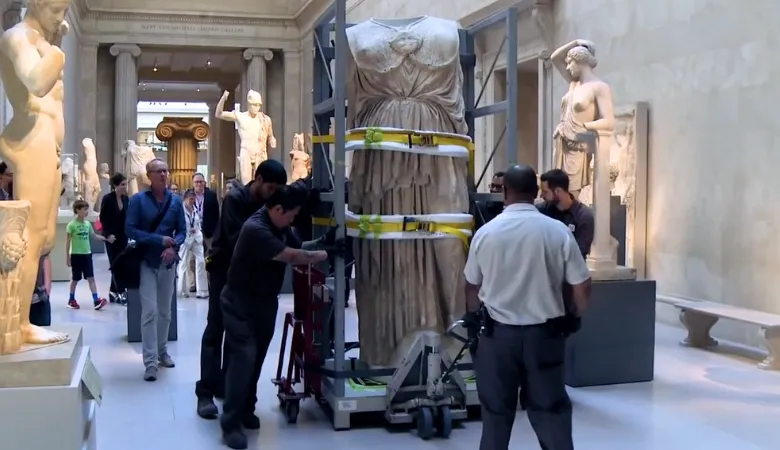 A still from the documentary showcasing historical artefacts being handled by museum workers 

