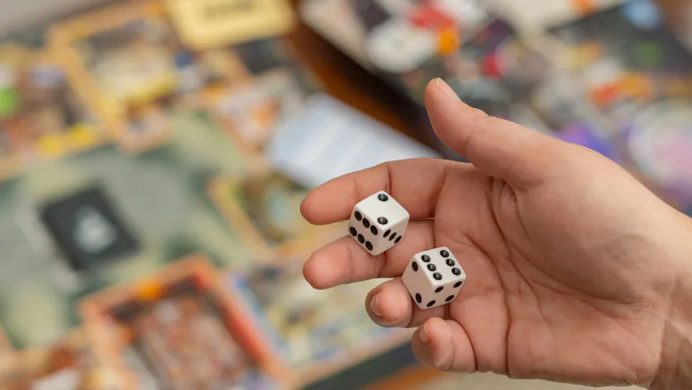 Woman's hand holding playing dice
