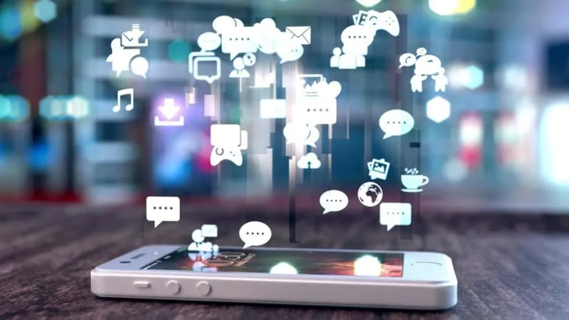 smartphone-on-a-table-with-social-media-icons-above-it-832x556