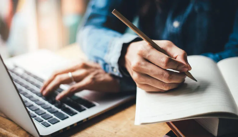 high school,college,university student using typing laptop via Shutterstock