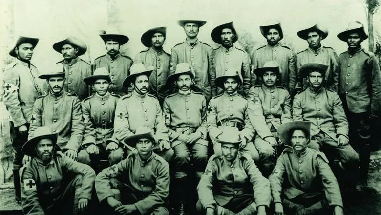 Gandhi sitting among members of the Natal Indian Ambulance Corps during the Boer War