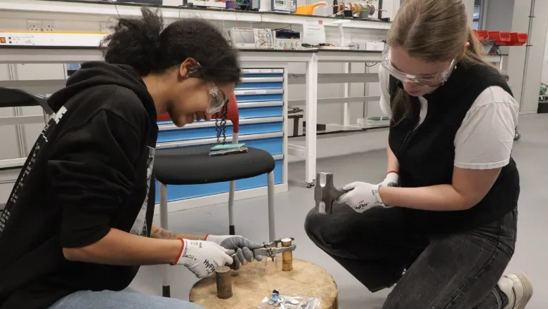 Students striking coins at King's Wheatstone Lab.