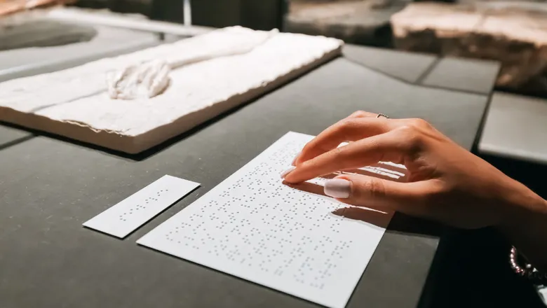 A blind person reads a braille print description of an educational exhibit at the Natural History Museum in Munster, Germany.