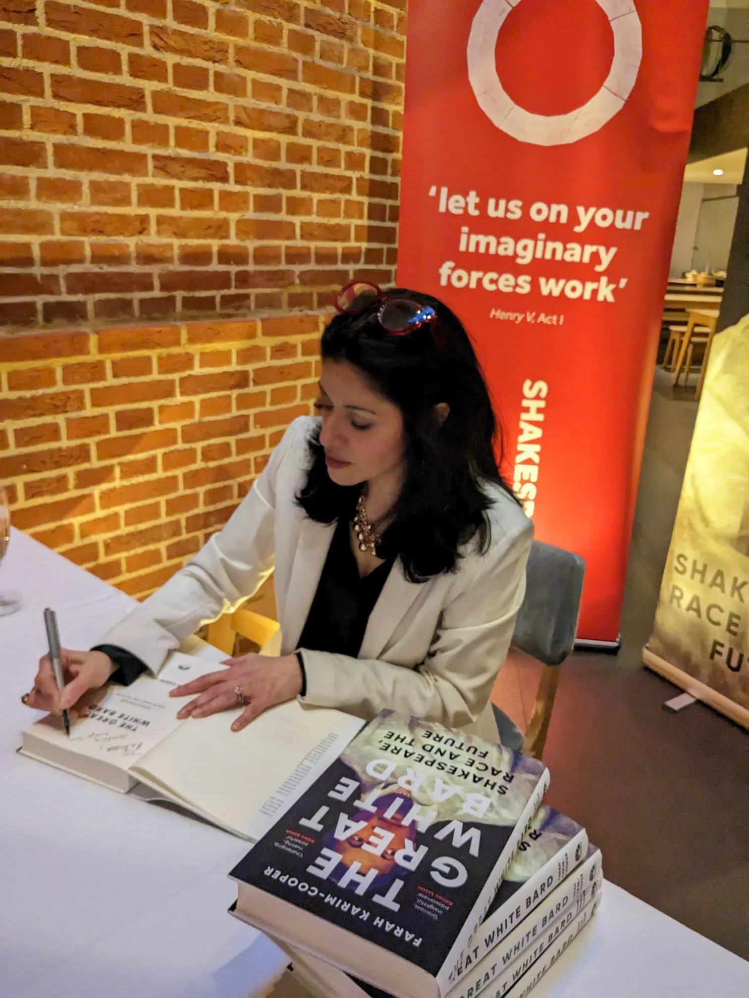 The photo shows Professor Farah Karim-Cooper signing the first copies of The Great White Bard