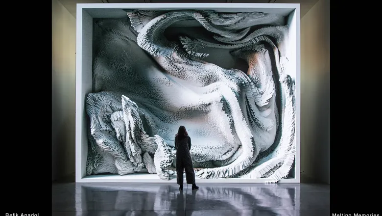 Person viewing Melting Memories, a video installation by Refik Anadol