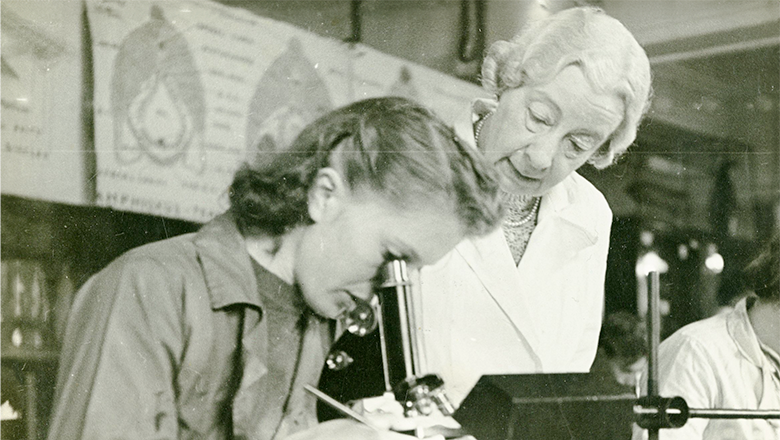 Professor Doris Mackinnon is pictured overseeing a student's research in 1943.