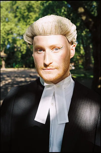 A head shot of Oscar in a barrister's gown and wig.