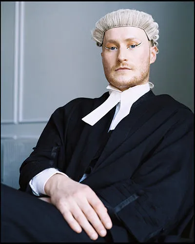A head shot of Oscar in a barrister's gown and wig.