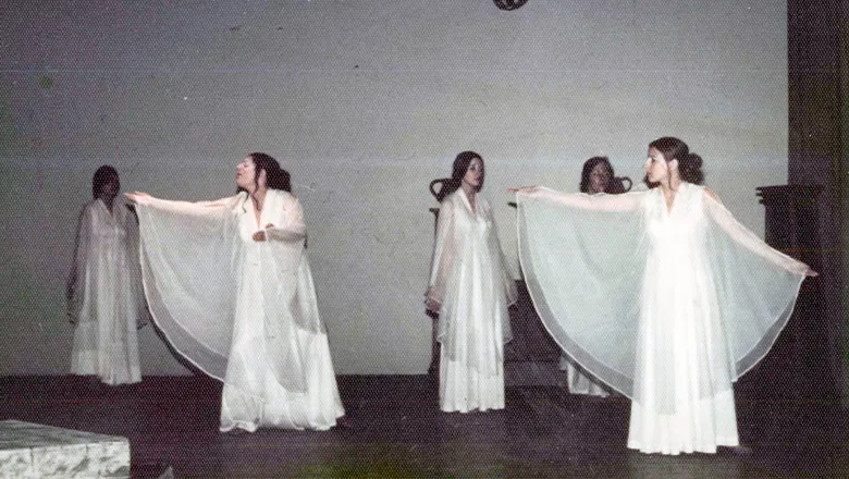 Mary (far right) as a member of the chorus in the Greek play Medea wearing a white flowy gown.
