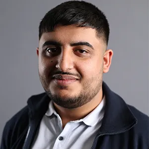 Mahdi Sadeghi, smiling slightly. He is wearing a dark jacket over a white shirt.