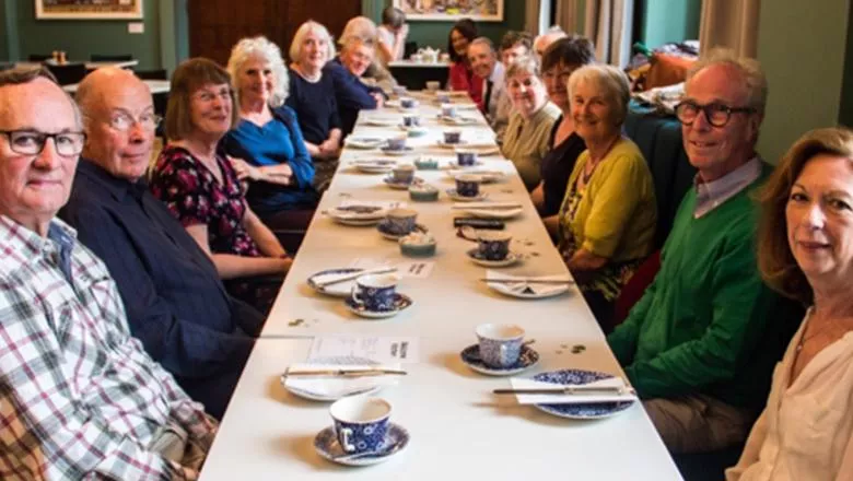 A group image of a reunion party having tea