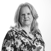 A black and white image of a woman in a floral shirt