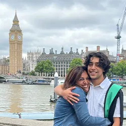 Ali and Sadi hug, standing in front of Big Ben.