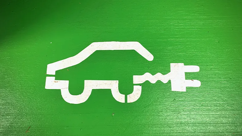 Graphic of a car and plug on a green background.