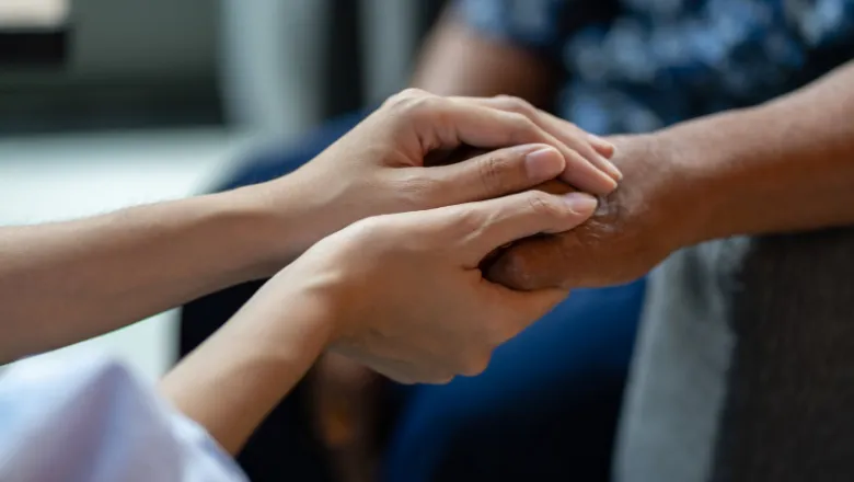 holding hand of patient giving comfort