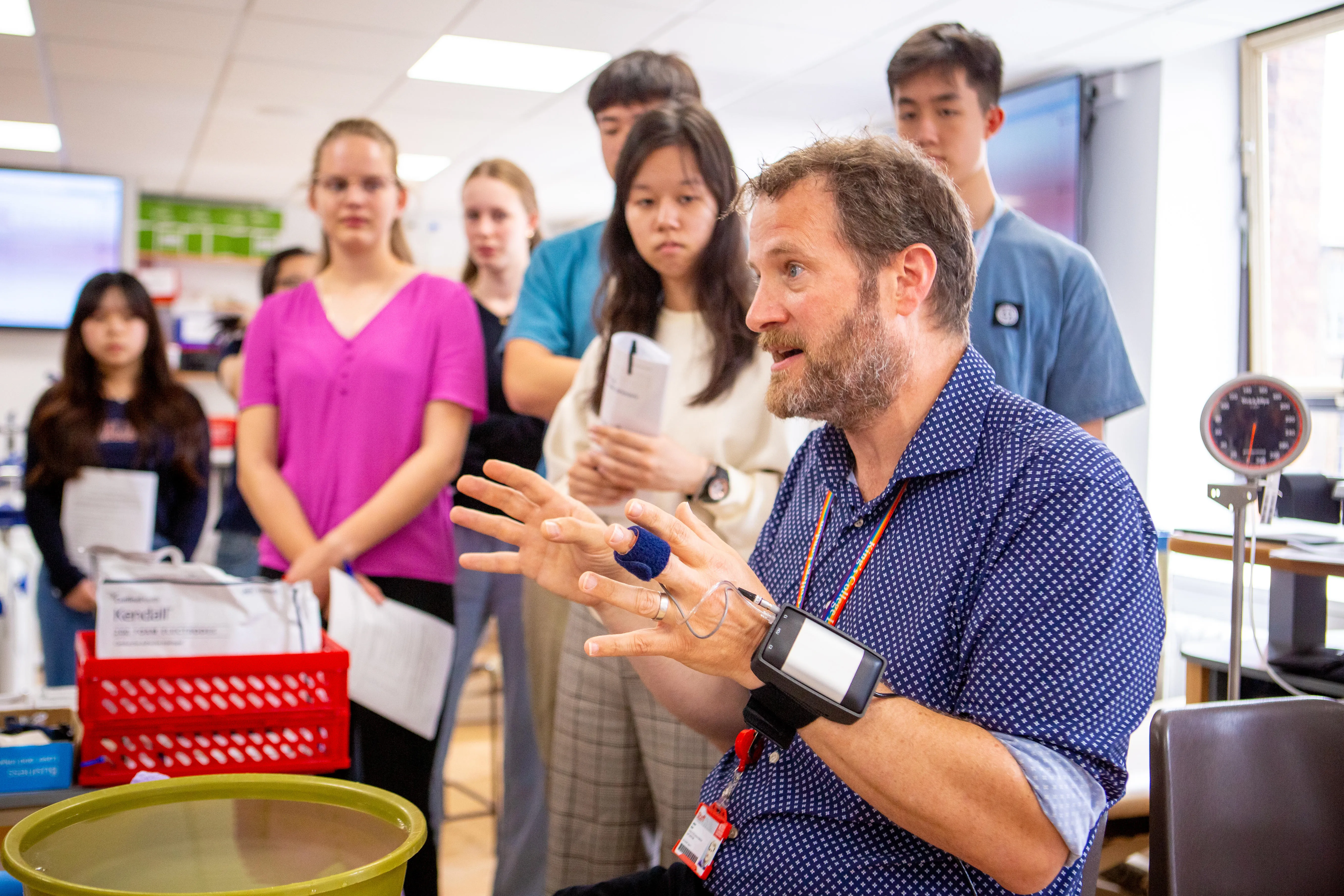 A staff member leading a group of students through an activity at a King's summer school.