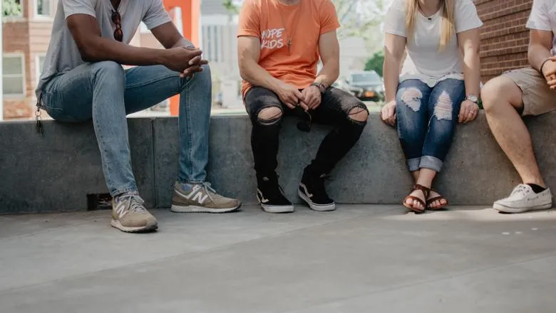 Teenagers sitting in a square