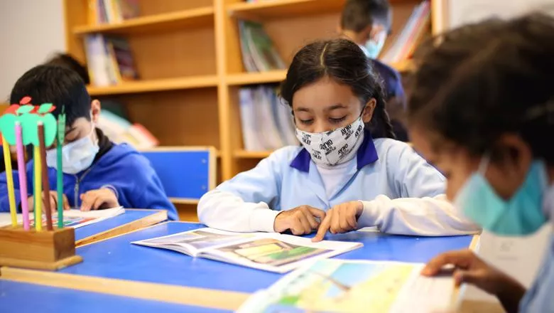 Girl at school with mask. Photo by Muneer ahmed ok on Unsplash
