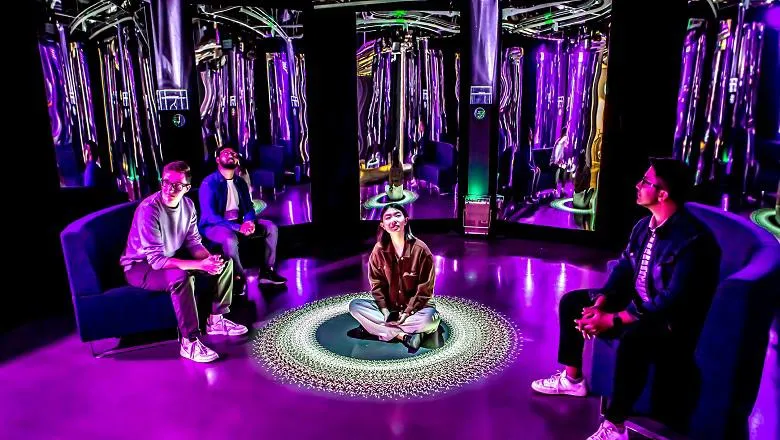 image of visitors at particle shrine exhibition purple background