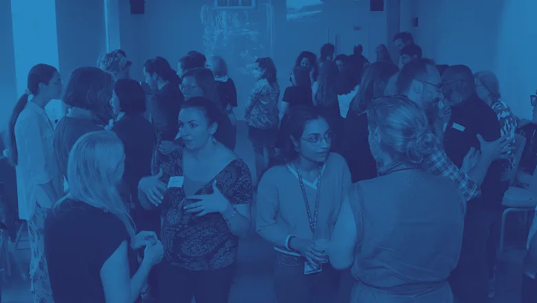group of researchers in conversation blue tinted image