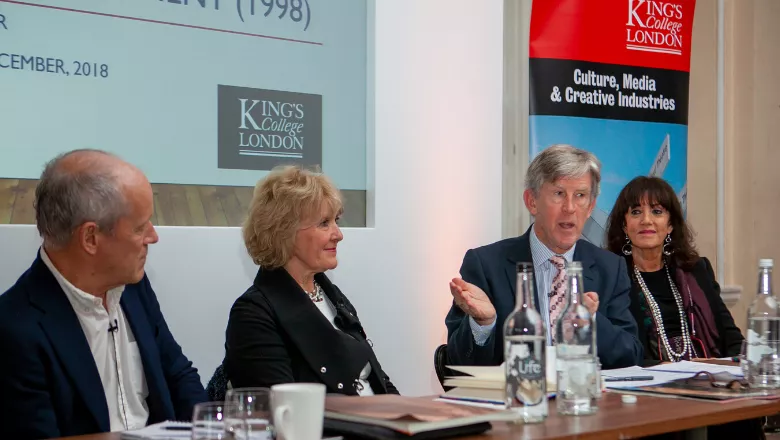 Four people participating in a panel discussion. 