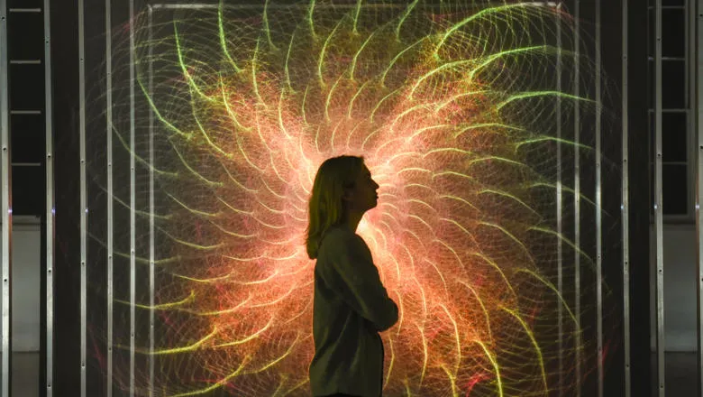 An image of a woman looking at the Tekja Awake installation at the 24/7 exhibition at Somerset House