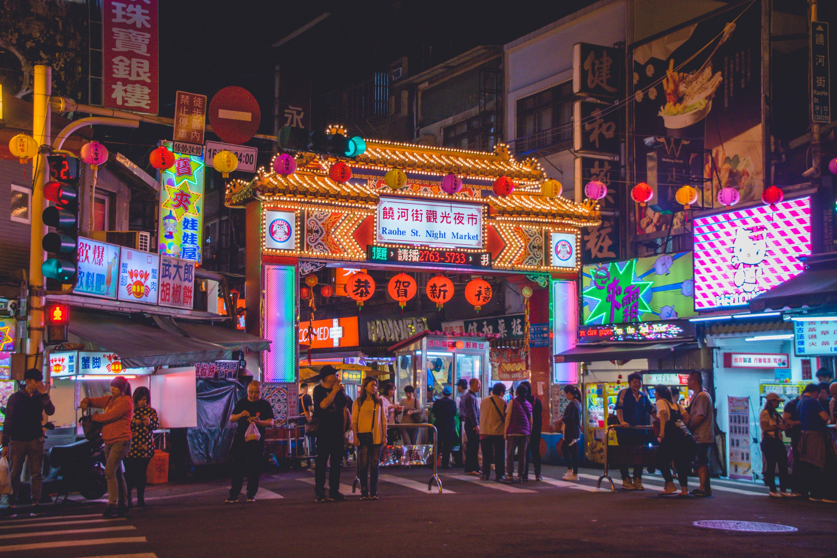 busy taiwan streets with neon lights at night