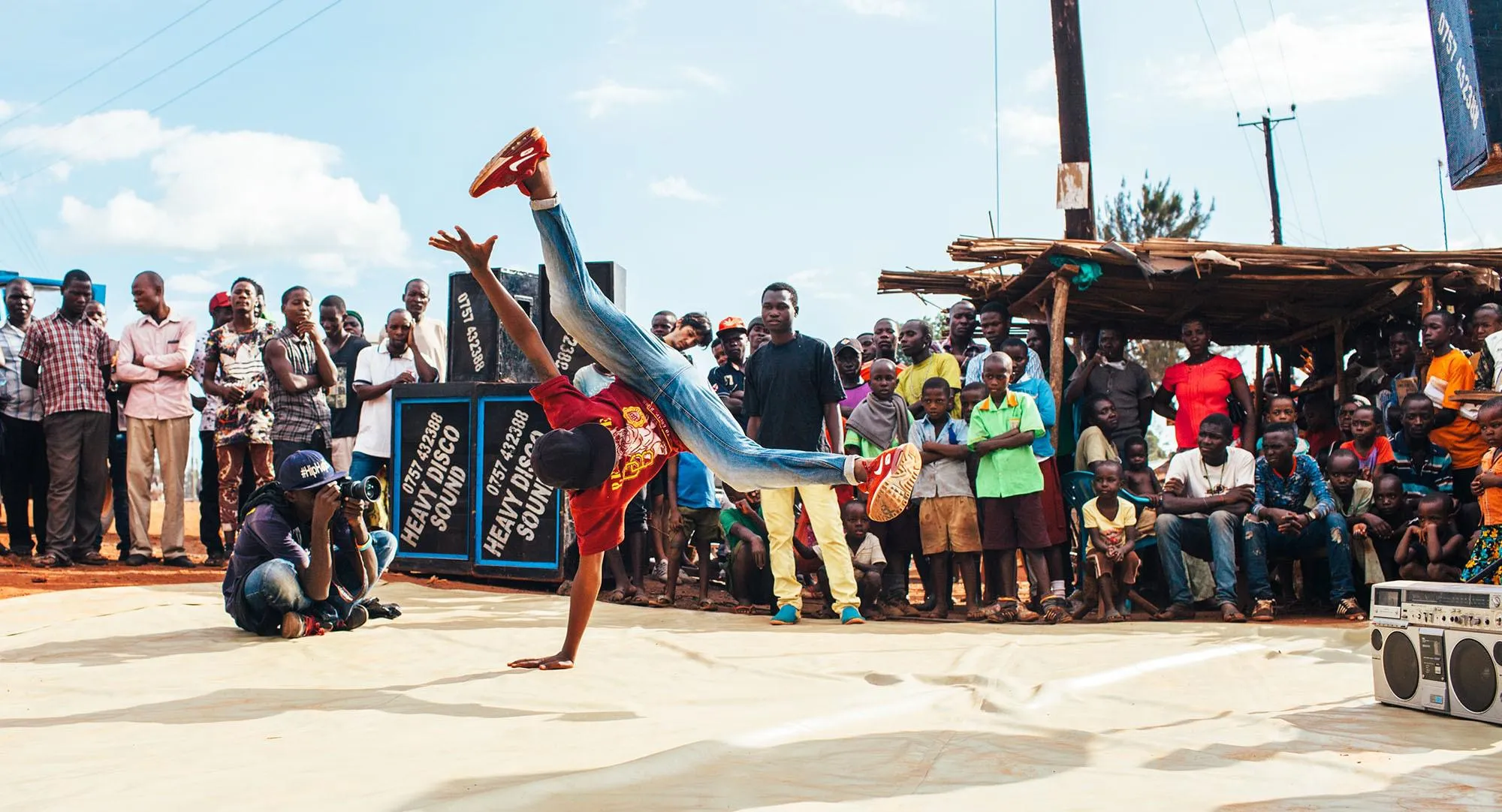 People breakdancing in front of a crowd in Uganda