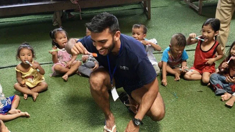 Utkarsh Dandekar demonstrates tooth brushing in Cambodia as part of his elective programme.