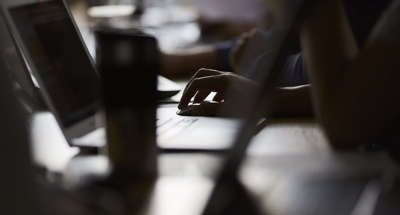 Close up of hand typing on a laptop.