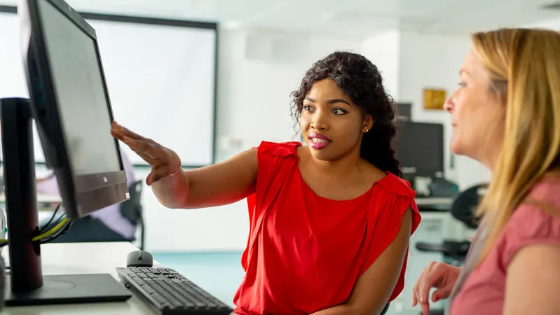 Woman pointing at computer screen
