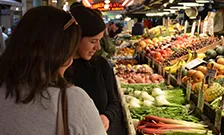 Two women looking at produce
