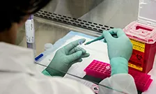 Scientist filling test tube