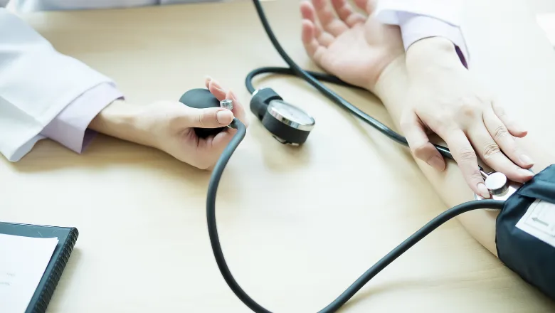 Doctor taking patient's blood pressure