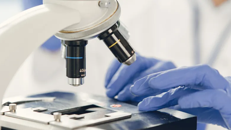 Researcher using microscope