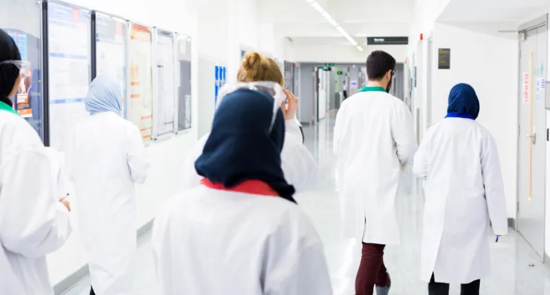 Students from the Institute of Pharmaceutical Science walking in corridor