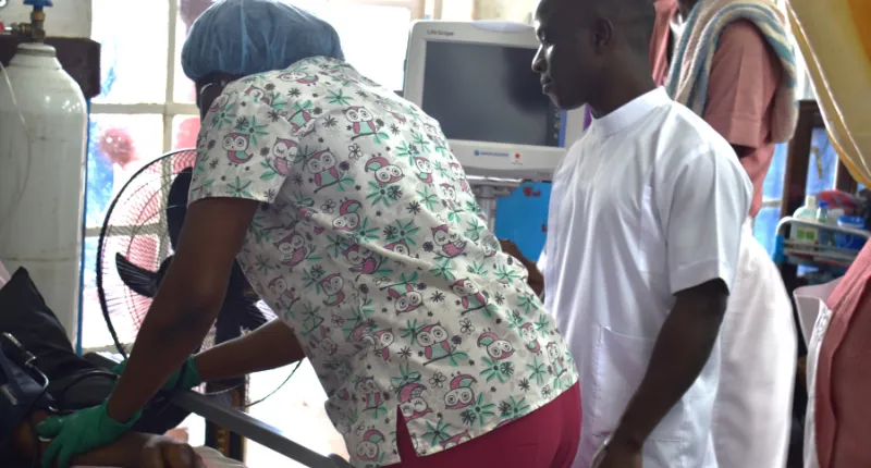 Health workers with patient stroke unit Connaught Hospital