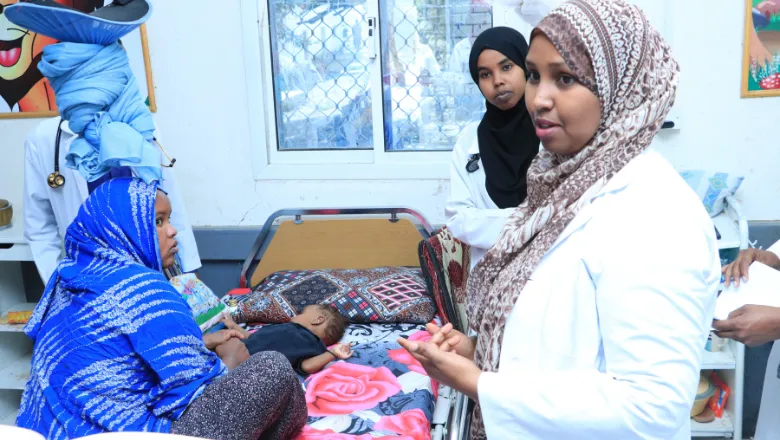 Doctor on her ward checks a mother and baby in Somaliland